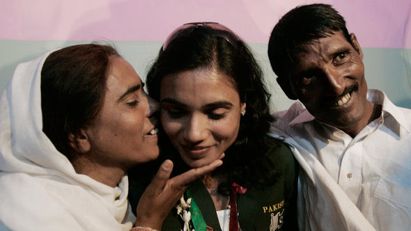 Nasreen (left) and Abdul Hameed flank their daughter Naseem, who won the gold medal in the women's 100-metre race at the 11th South Asian games in 2010 (photo: ddp images/AP Photo/Shakil Adil)