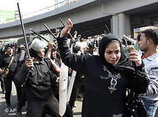 Members of the police force wielding batons against women during protests in Egypt (photo: AP)