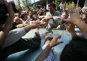 Enthusiastic supporters reaching out to shake the hand of Iranian President Mahmoud Ahmadinejad (photo: AP)