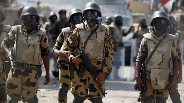 Army soldiers wear gas masks before clashes with members of the Muslim Brotherhood and supporters of deposed Egyptian President Mohamed Morsi at Republican Guard headquarters in Nasr City, a suburb of Cairo July 8, 2013 (photo: Reuters)