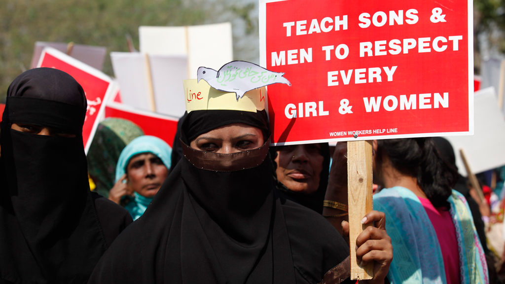 Activist hold placards as they take part in a rally to commemorate International Women's Day in Lahore March 8, 2013 (photo: Reuters)