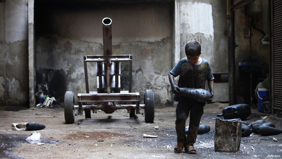 A Syrian child plays with ammunition (photo: Reuters)