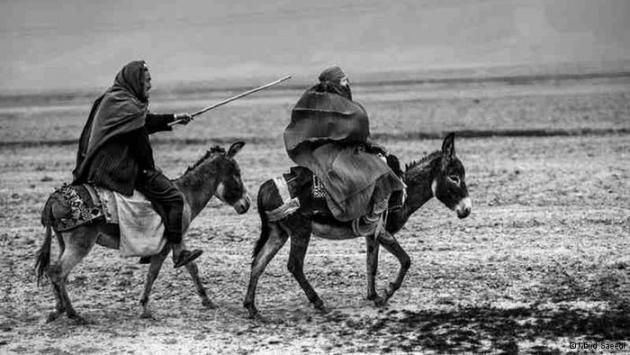 An Afghan man and an Afghan woman travelling by donkey (photo: Majid Saeedi)