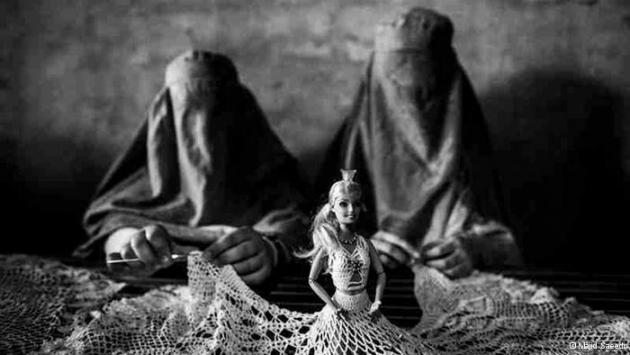 Women dressed in burqas making lace for a dress worn by a Barbie doll (photo: Majid Saeedi)