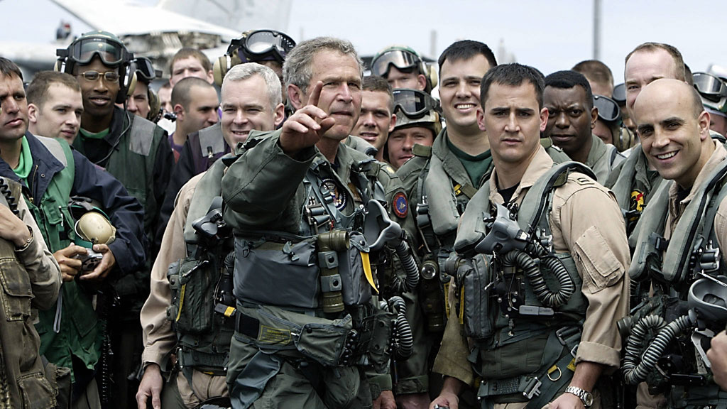 US President George W. Bush meets pilots and crew members of the aircraft carrier USS Lincoln on 1 May 2003 (HECTOR MATA/AFP/Getty Images)