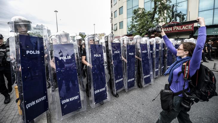 A photographer takes a photo of Turkish riot police officers standing in line as they block access to Taksim square on 31 May 2014 (photo: AFP/Getty Images)