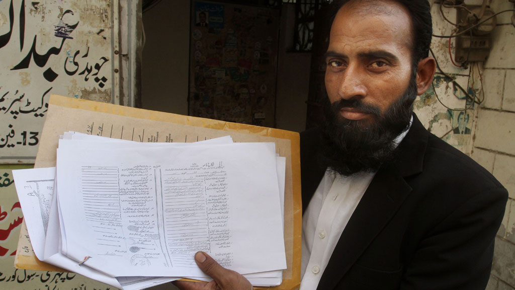 Mustafa Kharal, lawyer of pregnant woman Farzana Parveen, holds up her marriage certificate in Lahore, Pakistan, 28 May 2014 (photo: picture-alliance/AP Photo)