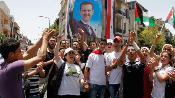 Assad supporters celebrate during an election event in Damascus (photo: Reuters/Khaled al-Hariri)