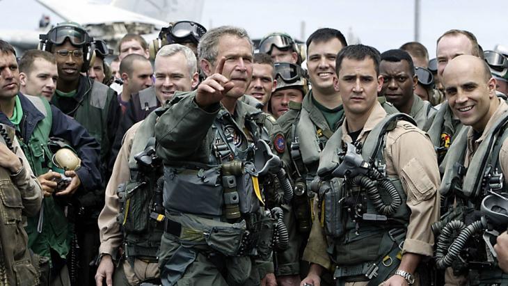 US President George W. Bush meeting pilots and crew members of the aircraft carrier USS Lincoln on 1 May 2003 (HECTOR MATA/AFP/Getty Images)
