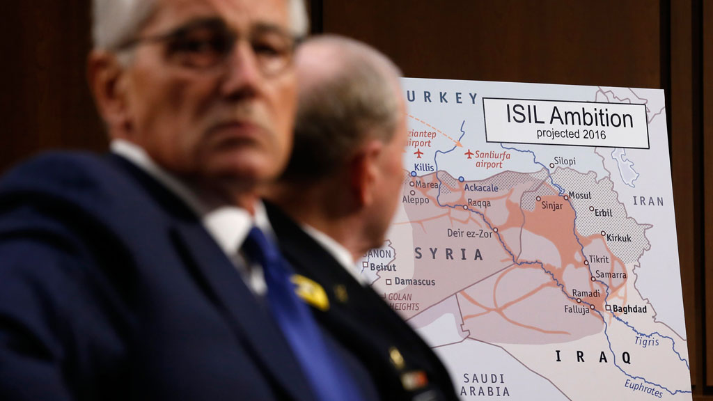 U.S. Secretary of Defense Chuck Hagel (left) and Chairman of the Joint Chiefs of Staff Gen. Martin Dempsey look at a map showing Islamic State ambition, Washington, September 2014 (photo: Reuters/Kevin Lamarque 