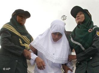 A woman is held by members of the Sharia police in Banda Aceh (photo: AP)
