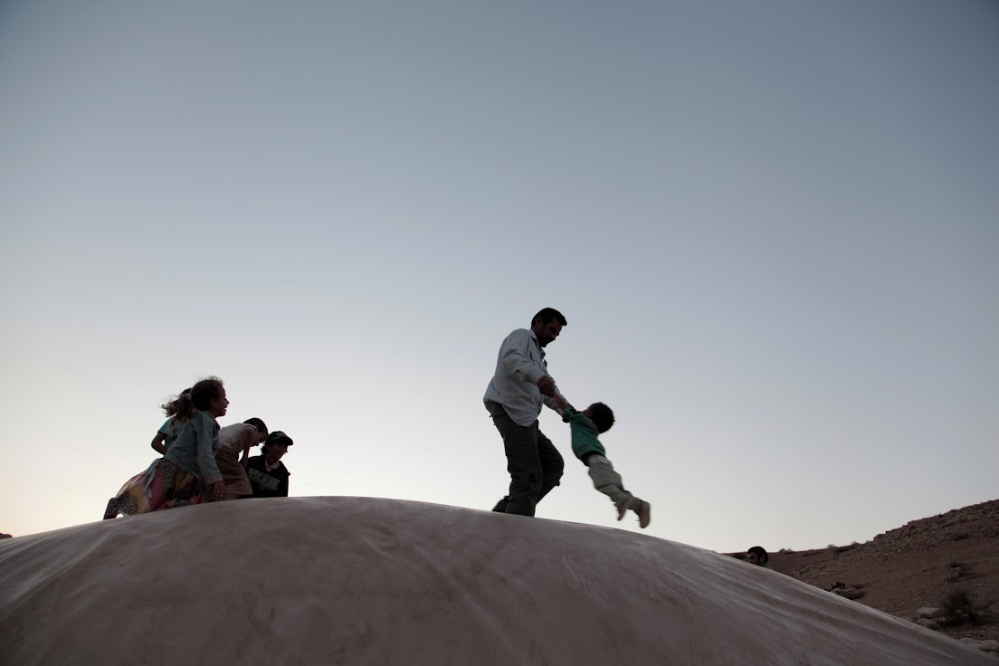 A Bedouin man plays with his children, Al-Maleh, West Bank, October 2014 (photo: Mohammad Alhaj)