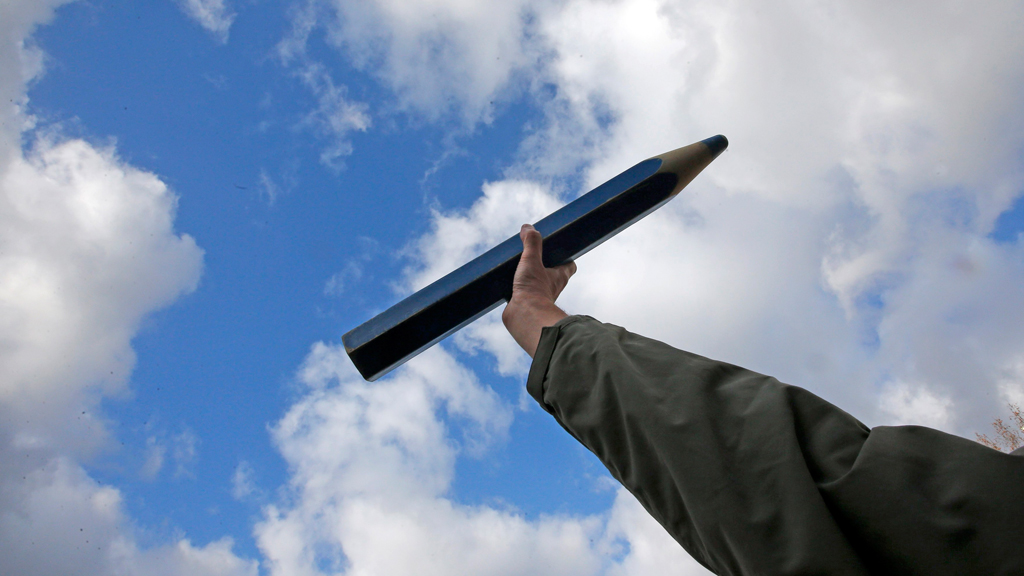 A man holds up an oversized pencil as he takes part in a solidarity march, Paris, 11 January 2015 (photo: Reuters/Gaillard)