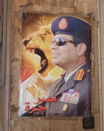 A poster depicting Abdul Fattah al-Sisi beside the Egyptian flag and the head of a lion (photo: Arian Fariborz)