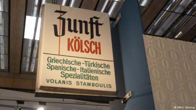 A sign advertising Kolsch beer from Cologne as well as Greek, Turkish, Spanish and Italian food (photo: DW/J. Hennig)