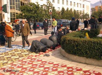 Men praying outside Et'hem Bey Mosque, Tirana, Albania
