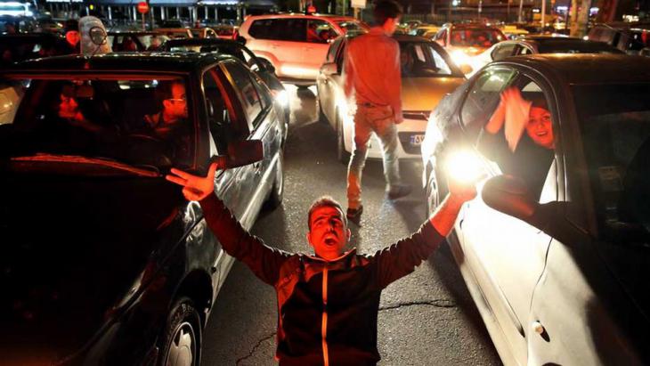 People celebrate on the streets of Tehran following news of the Lausanne agreement (photo: Reuters) 