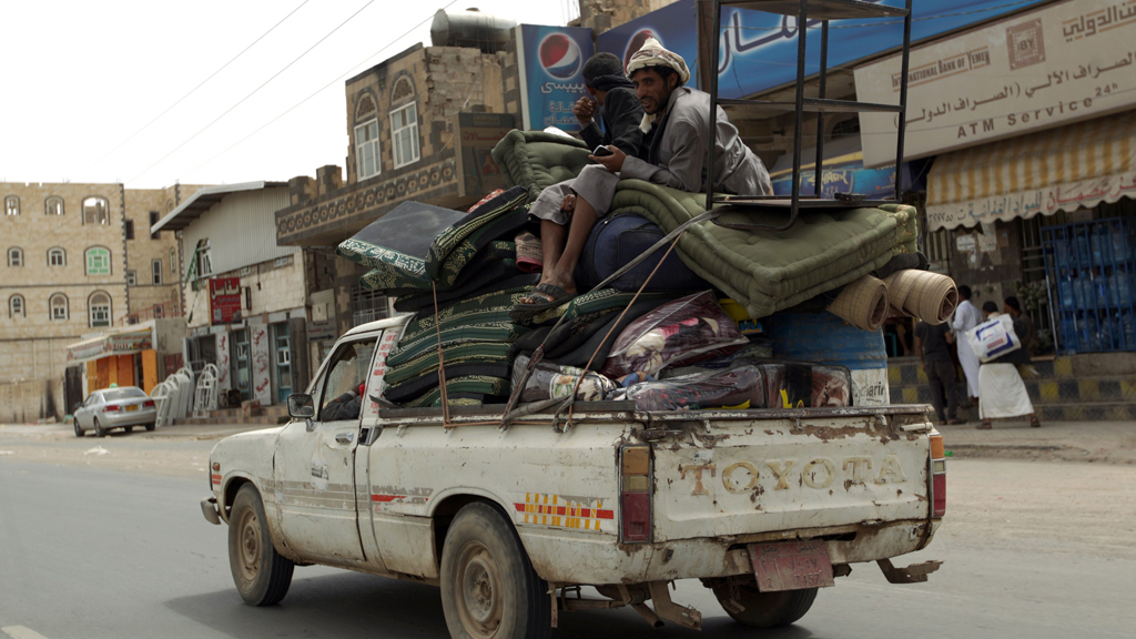 Yemenis fleeing Sanaa in a pick-up truck loaded with personal belongings (photo: AFP/Getty Images/M. Huwais)