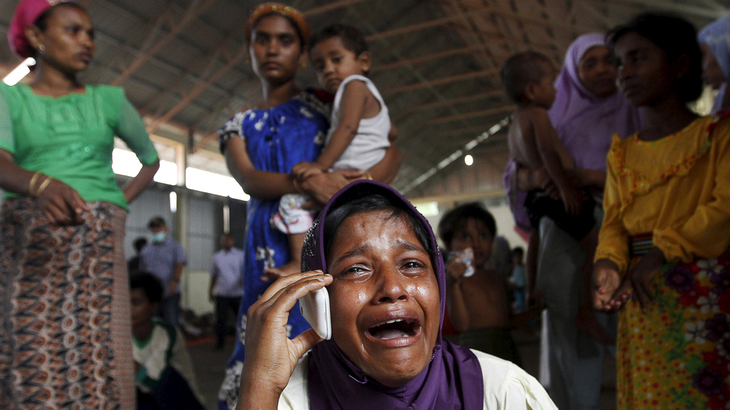 Migrant crying on a mobile phone, Kuala Langsa, Indonesia (photo: Reuters/R. Bintang)