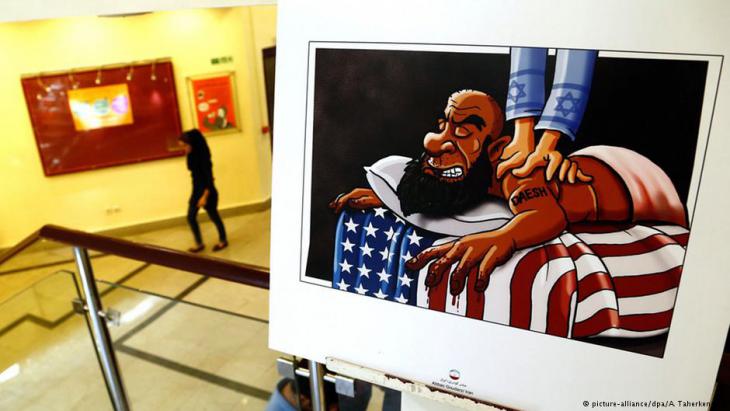 Cartoon showing an IS fighter lying on an American flag being massaged by an Israeli (photo: picture-alliance/dpa/A. Taherkenareh)