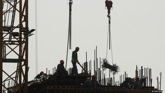 Foreign workers on a construction site in Doha, Qatar (photo: Getty Images)