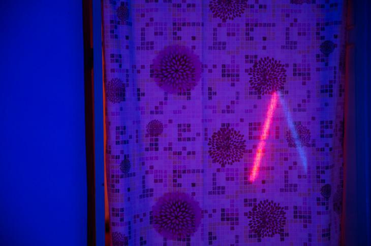 Red light issues from the mock-up of a prostitute’s room in the installation ″Grande Maison″ (photo: Soliman/Gielens)
