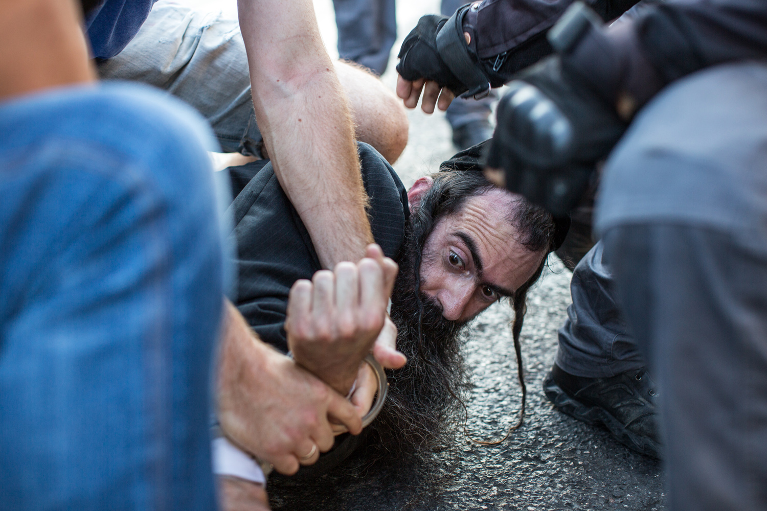 Knife-wielding assailant is wrestled to the ground at Jerusalem's Gay Pride Parade (photo: Emil Salman/ Haaretz)