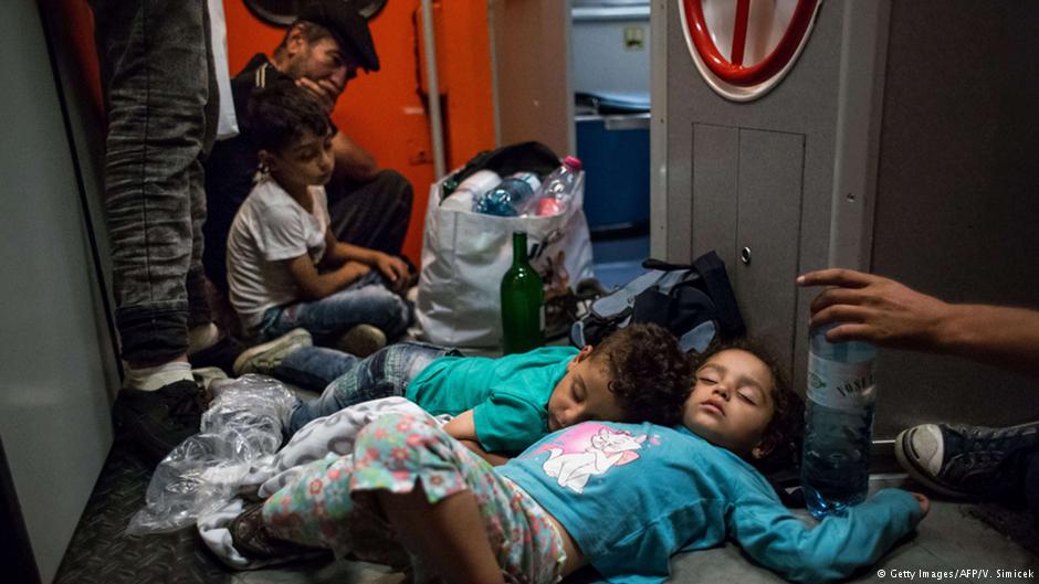 Exhausted refugee children en route through Hungary and Austria