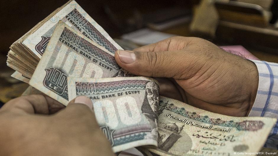 Counting out Egyptian pounds in a Cairo shop 