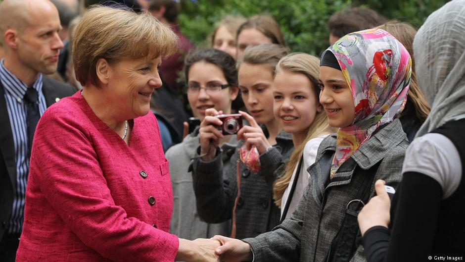German Chancellor Angela Merkel greets students at the Sophie Scholl senior school in Berlin during a visit on the fifth European School Project Day in 2011