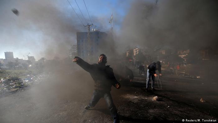 A Palestinian protester hurls stones towards Israeli police during clashes as Palestinians call for a day of rage in response to U.S. President Donald Trump's decision to recognise Jerusalem as Israel's capital, near the Jewish settlement of Beit Al, near the West Bank city of Ramallah (photo: Reuters/M. Torokman)