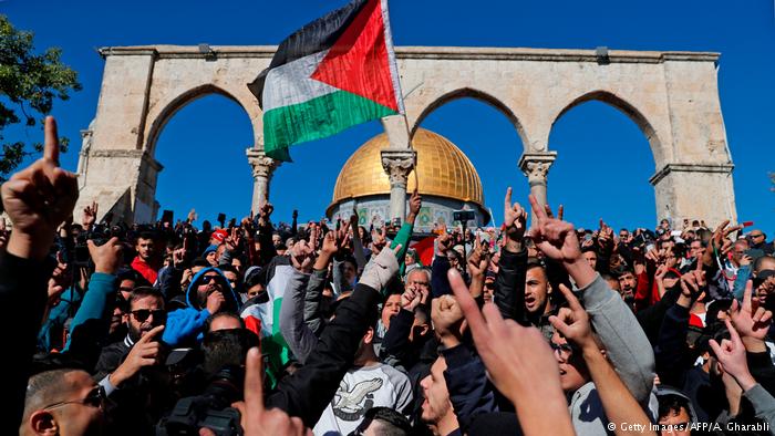 Palestinian protesters shout slogans in front of the Dome of the Rock mosque at the al-Aqsa mosque compound in Jerusalem's Old City. Hundreds of additional police were deployed to control the masses of protestors after Palestinian calls for protests following Friday prayers (photo: Getty Images/AFP/A. Gharabli)