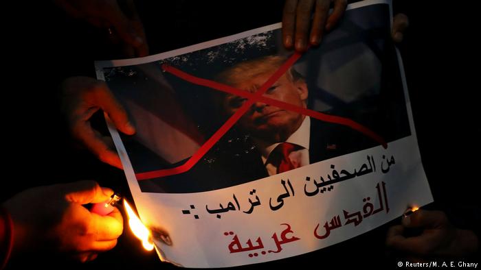 Protesters in Egypt burn a picture of U.S. President Donald Trump with his face crossed out during a protest in front of the Syndicate of Journalists in Cairo. The picture reads, Journalists are telling you Trump, Jerusalem in Arab. Hundreds of protesters also gathered in Al-Azhar mosque and outside in its courtyard (photo: Reuters/M. A. E. Ghany)