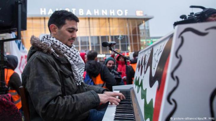 Aeham Ahmad playing his piano outside Cologne Central Station (photo: picture-alliance/dpa/M. Hitij)