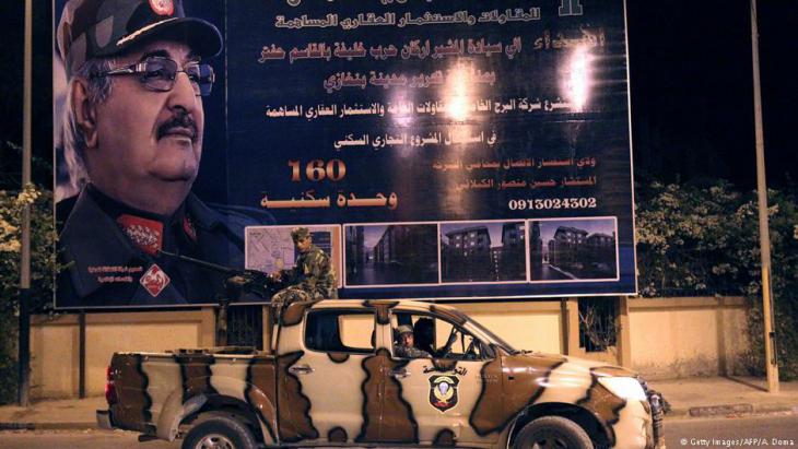 Army vehicle in front of a billboard depicting General Khalifa Haftar in Benghazi (photo: Getty Images/AFP)
