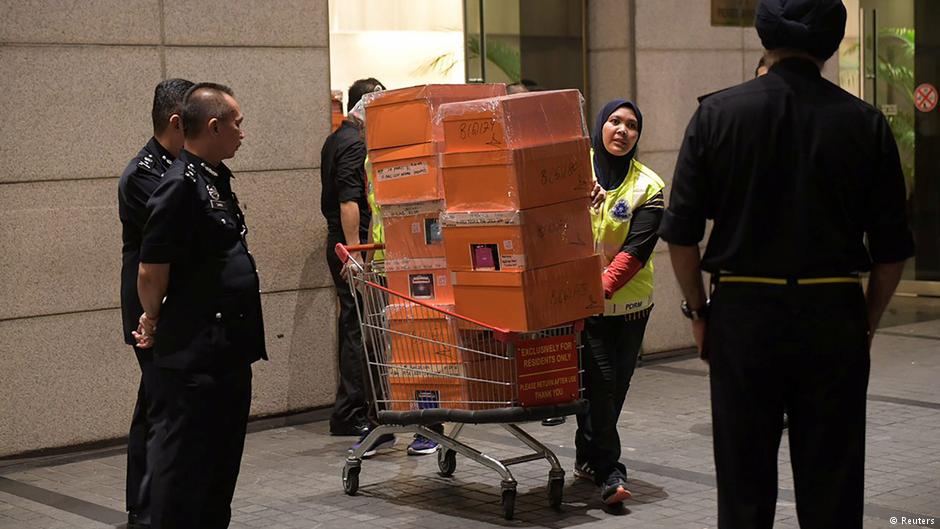 A Malaysian police officer pushes a trolley during a raid of three apartments in a condominium owned by former Malaysian prime minister Najib Razak’s family, in Kuala Lumpur, on 17 May 2018, in this photo taken by The Straits Times (source: Reuters)