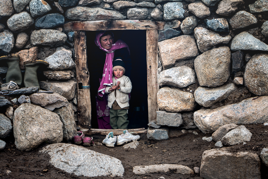 A Wakhi shepherdess with her child in their rock shelter (photo: Camille Del Bos)