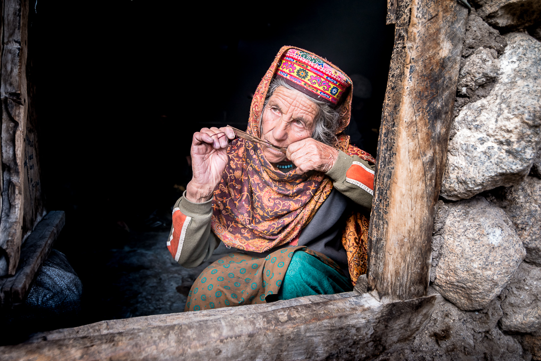 Old Wakhi woman playing a wooden mouth harp in her shepherd's hut (photo: Camille Del Bos)