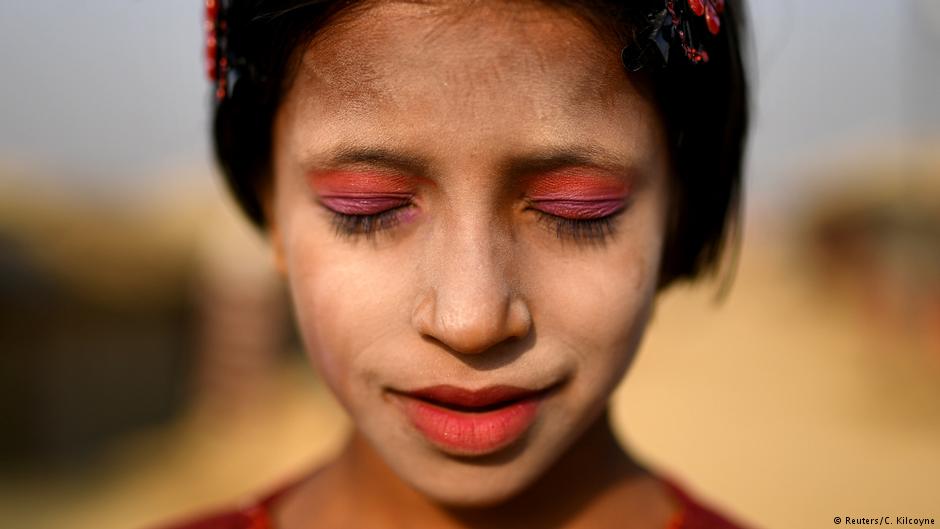 A Rohingya refugee girl named Amina poses for a photograph as she wears thanaka paste at Kutupalong camp in Cox's Bazaar, Bangladesh, 30 March 2018 (photo: Reuters/Clodagh Kilcoyne)