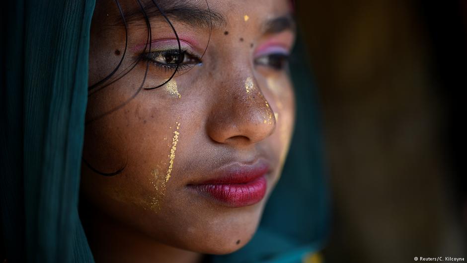 A Rohingya refugee girl named Razina Begum, aged 16, poses for a photograph as she wears thanaka paste at Jamtoli camp in Cox's Bazaar, Bangladesh, April 1, 2018. "I use the make up to make my face clean and fresh. I wear it everyday," said Razina (photo: Reuters/Clodagh Kilcoyne)