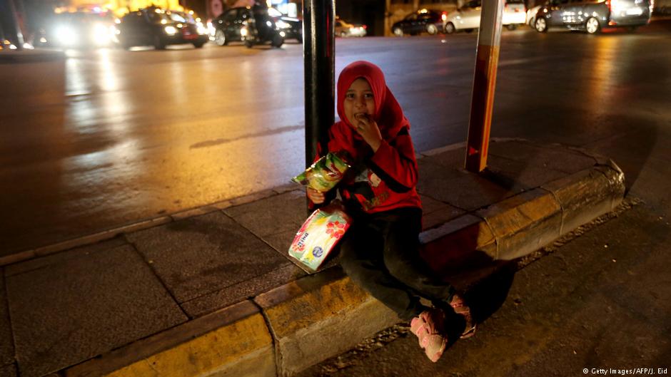 A Syrian refugee girl sells tissue paper on a busy intersection in the Lebanese capital Beirut, late on 24 October 2015 (photo: Getty Images/AFP/J. Eid)