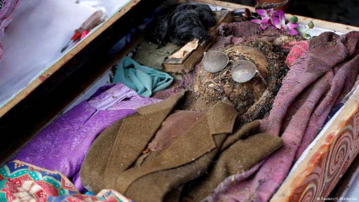 Mummified remains of a man revealed during the opening of a coffin by relatives at Loko'mata, an ancient Torajan burial site, during the Ma'nene death ritual near Rantepao (North Toraja) on Sulawesi (photo: Darren Whiteside/Reuters)