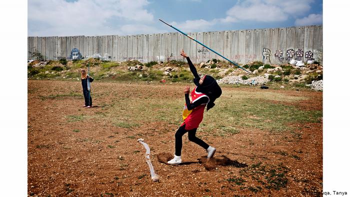 Young Muslim girls throwing javelins (photo: Tanya Habjouqa)