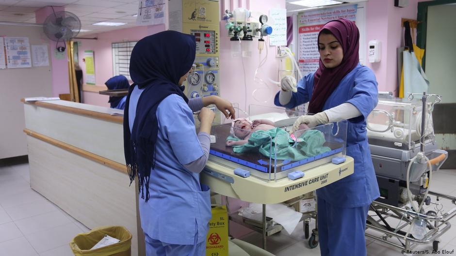 Midwife Sara Abu Taqea (right) weighs a new-born in the maternity ward at Gaza's Al-Ahli hospital (photo: Reuters/Samar Abo Elouf)
