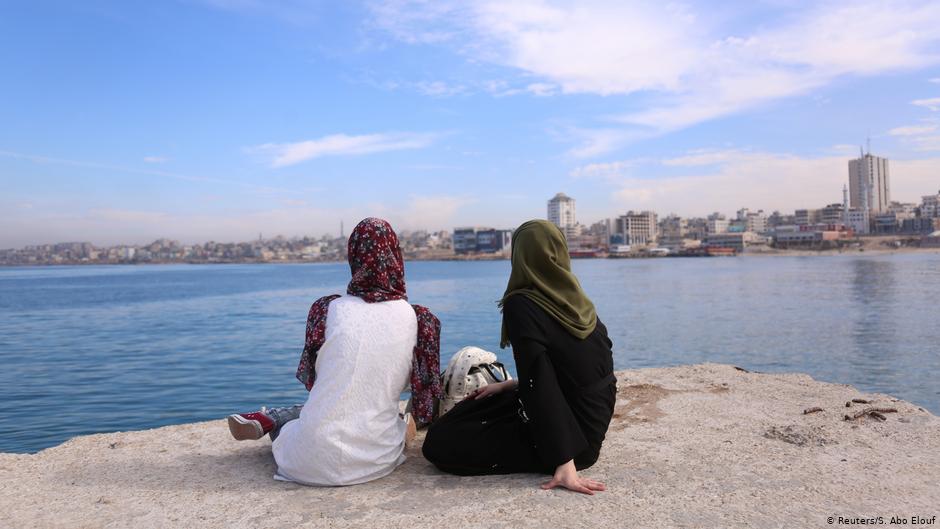 Sara Abu Taqea (right) who works in the maternity ward at Gaza's Al-Ahli hospital, and her friend at the seaport in Gaza City (photo: Reuters/Samar Abo Elouf)