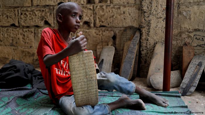 Omar Wone, 8, from Futa, sits on the floor of the daara (photo: Zohra Bensemra)