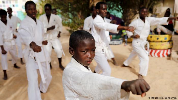Demba attends karate training in the courtyard of Maison De la Gare (photo: Zohra Bensemra)