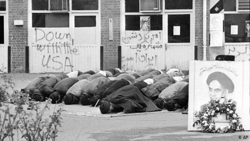 Iranian students pray inside the American Embassy compound before anti-American slogans on the third day of the occupation of the embassy in Tehran, Iran on 6 November 1979 (photo: AP)