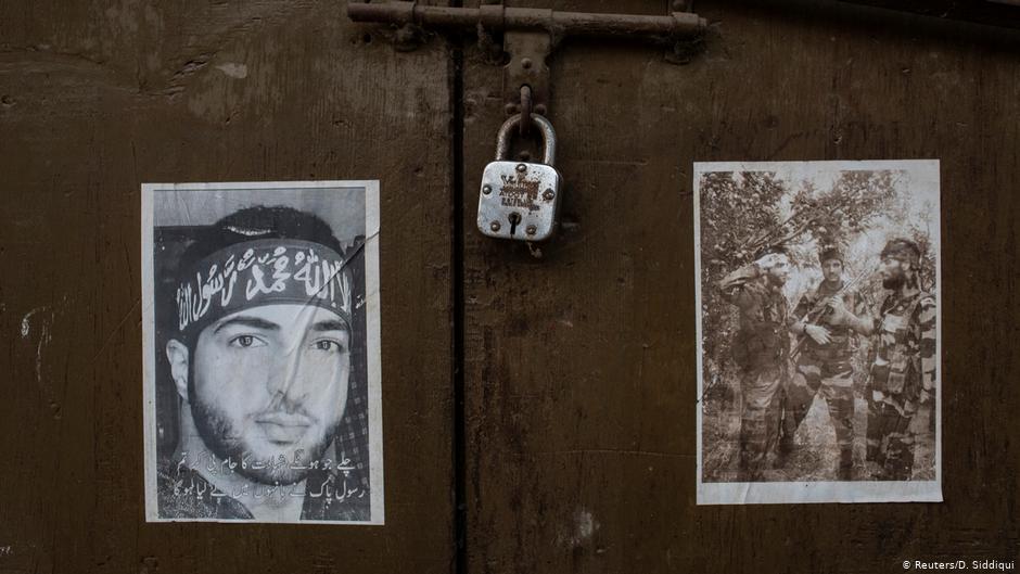 Pictures of dead militants are seen pasted on the door of a closed shop (photo: Reuters/D. Siddiqui)