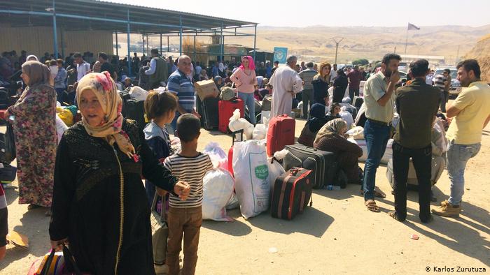 Syrian-Kurdish families at the border crossing in Semalka, Syria